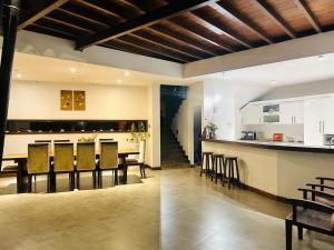 a kitchen and living room with a bar and chairs at 47 - Your Ultimate Relaxation in Colombo in Pannipitiya