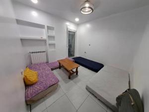 a room with two beds and a table in it at Apartment rental for vacations in Boumerdes