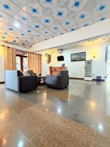 a large room with two couches and a table at Hotel Camorich in Tissamaharama