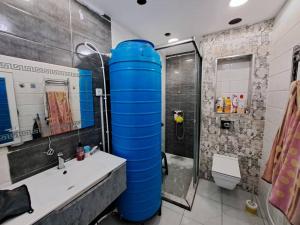 a bathroom with a large blue water tank at Apartment rental for vacations in Boumerdes