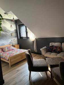 a bedroom with a bed and a couch and a chair at Agroturystyka Myślinów - Black Horse Bar&Grill in Męcinka +45 photos