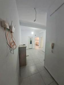 a white room with a hallway with a table in it at Apartment rental for vacations in Boumerdes +6 photos