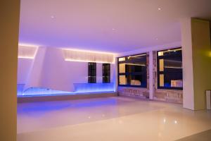a swimming pool in a house with purple lighting at Aeon Blue in Selianitika
