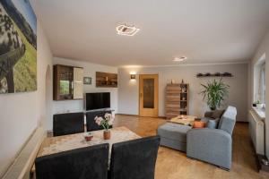 a living room with a couch and a table at Ferienhaus Pöhlablick in Pöhla