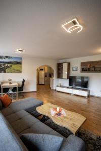 a living room with a couch and a table at Ferienhaus Pöhlablick in Pöhla