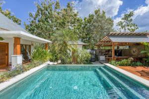 a swimming pool in the backyard of a house at Noho Stay Bali in Uluwatu