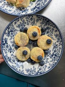 two plates of food with blue berries on them at Готель White House in Yablunytsya