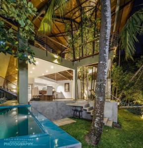 a house with a pool and a table and a tree at 47 - Your Ultimate Relaxation in Colombo in Pannipitiya