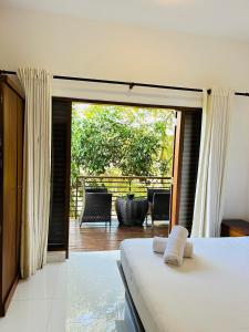 a bedroom with a bed and a view of a patio at 47 - Your Ultimate Relaxation in Colombo in Pannipitiya +121 photos