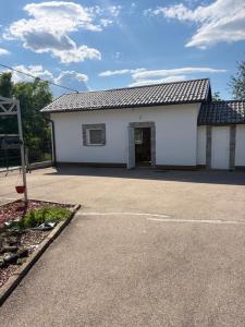a white building with a garage at Villa Eden Prijecani in Banja Luka