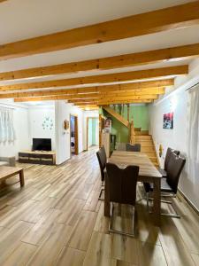 a dining room with a wooden table and chairs at Villa Eden Prijecani in Banja Luka