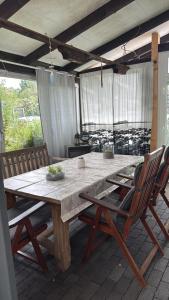 a large wooden table with chairs on a patio at Ferienwohnung & Monteurwohnung Oberburg in Solingen
