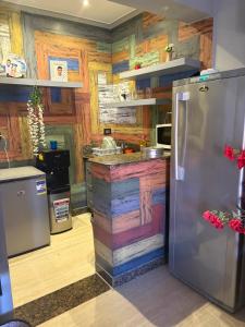 a kitchen with wooden walls and a stainless steel refrigerator at Apartment in a villa with pool and garden in Cairo