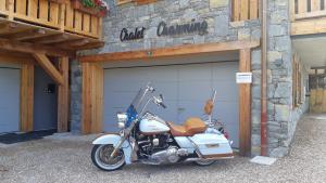 a motorcycle parked in front of a garage at CHALET CHARMING BED and BREAKFAST in Les Gets