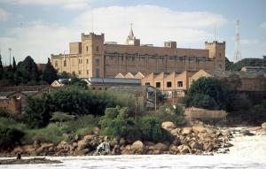 a large building next to a body of water at Pousada Sol do Salto Estância in Salto