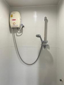 a shower with a hose attached to a wall at City Residence Rama 6 in Bangkok +24 photos