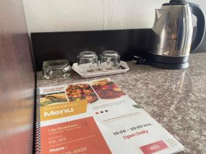 a menu on a counter next to a coffee maker at City Residence Rama 6 in Bangkok