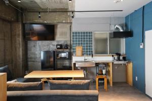 a kitchen with a wooden table in a room at Liminal in Atami