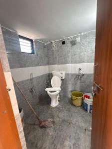 a bathroom with a toilet in a room at Nishhh stay in Surūrnagar