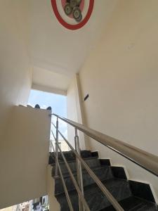 a staircase in a building with a clock on the wall at Nishhh stay in Surūrnagar