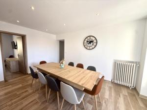a dining room with a wooden table and chairs at Les Ecrins in Vigneulles-lès-Hattonchâtel