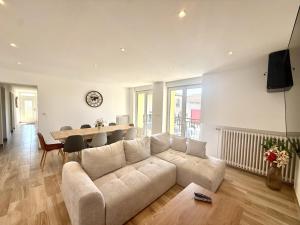 a living room with a couch and a table at Les Ecrins in Vigneulles-lès-Hattonchâtel +4 photos