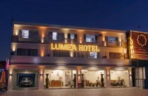 a hotel with a car parked in front of it at Khách sạn Lumea in Cam Ranh