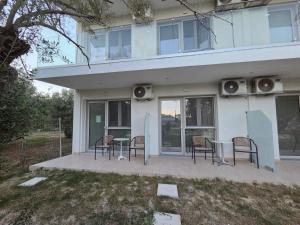 a house with a patio with chairs and speakers at VasilikiApartments in Vasiliki