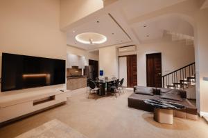 a living room with a large flat screen tv at Woods Luxury Villas in Lonavala