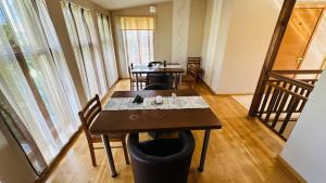 a dining room with a wooden table and chairs at Liepas in Ventspils +29 photos