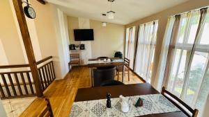 a living room with a table and a dining room at Liepas in Ventspils