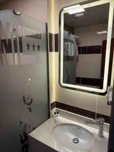 a bathroom with a sink and a mirror at Nil Hotel in Gaziantep