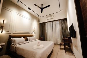 a hotel room with a bed with a cross on the ceiling at Woods Luxury Villas in Lonavala +118 photos