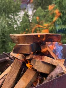 a pile of wood and fire in a grill at Chalet Panorama (Апартаменти) in Bukovel +148 photos