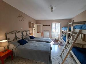 a bedroom with two bunk beds and a ladder at La Fantesca in Pettorano sul Gizio