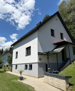 a white house with a black roof at Ferienhaus Meisterl in Sankt Marein bei Neumarkt