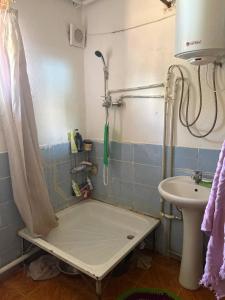 a bathroom with a shower and a sink at Jumgal Nomad House in Kyzart