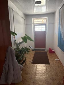 a room with a door and a potted plant at Jumgal Nomad House in Kyzart