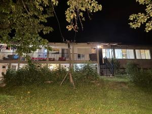 a house with a porch at night at guesthouse twins in svaneti in Mestia