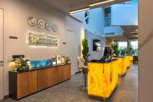 a lobby of a restaurant with a row of counters at Effect Grand Victoria Hotel - Ultra All Inclusive in Sunny Beach +104 photos