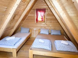 a bedroom with two beds in a attic at Rafting centar RT in Foča +127 photos