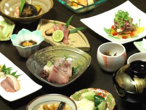 a table with many plates of food on it at 縁の宿 北堀 in Matsue