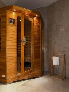 a wooden shower with a glass door in a room at Zámoček Mraznica in Prievidza +64 photos