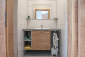 a bathroom with a sink and a mirror at Ferienwohnung Döller in Gmünd +13 photos