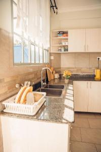 a kitchen with a sink and a counter top at Lights & Kulture Homes in Arusha