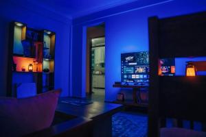 a blue room with a desk with a computer in it at Lights & Kulture Homes in Arusha
