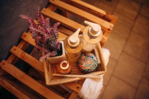 a basket with hats and a vase on a chair at Lights & Kulture Homes in Arusha +33 photos