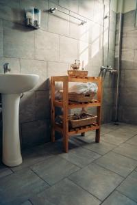 a bathroom with a sink and a toilet and a shower at Lights & Kulture Homes in Arusha