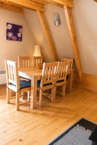 a dining room with a wooden table and chairs at Holiday Home Stefani Spacious Mountain House near Durmitor 3 Bedrooms Private Parking in Žabljak