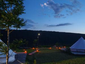 a tent and a street light in a field at night at ILLU Glamping in Trebujeni +3 photos